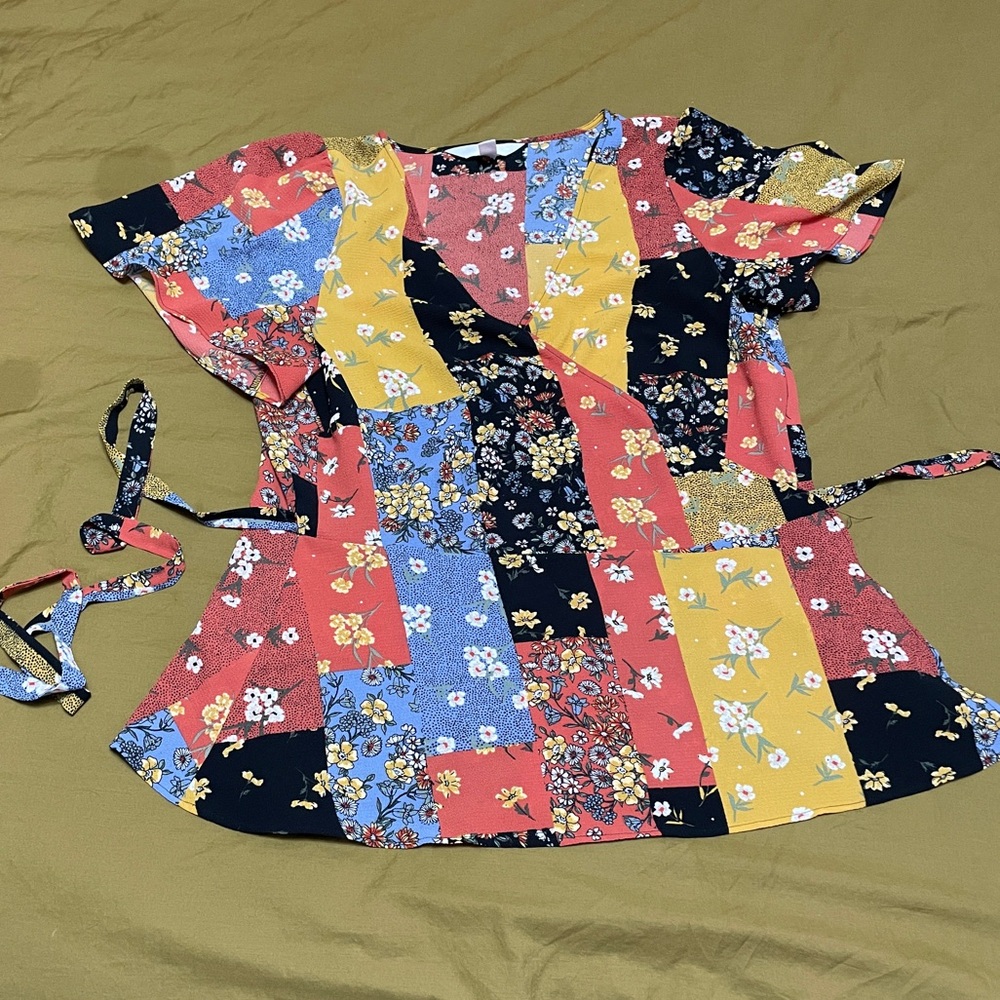 Patchwork patterned peplum wrap top